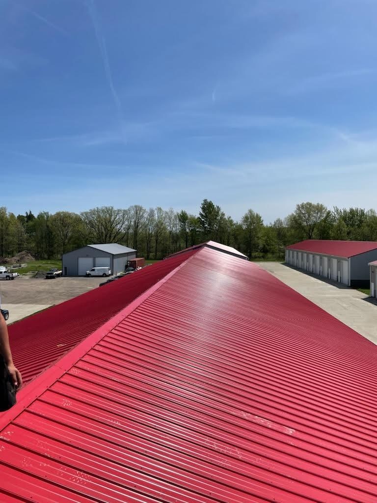 New standing-seam red metal roof on a commercial storage facility